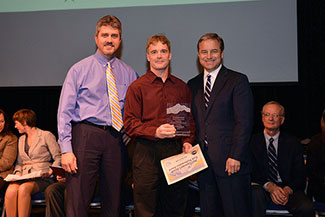 Photo of Rob Massengill receiving Exceptional Performance award